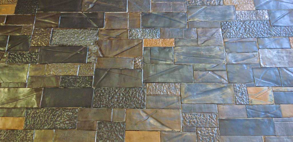 Handmade ceramic tiles with Metal glazes and mixtures of textured surfaces