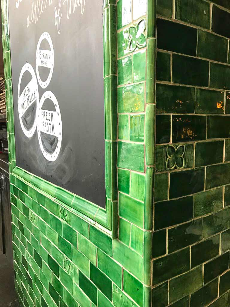 The architectural moulding of these green tiles makes for a perfect finish