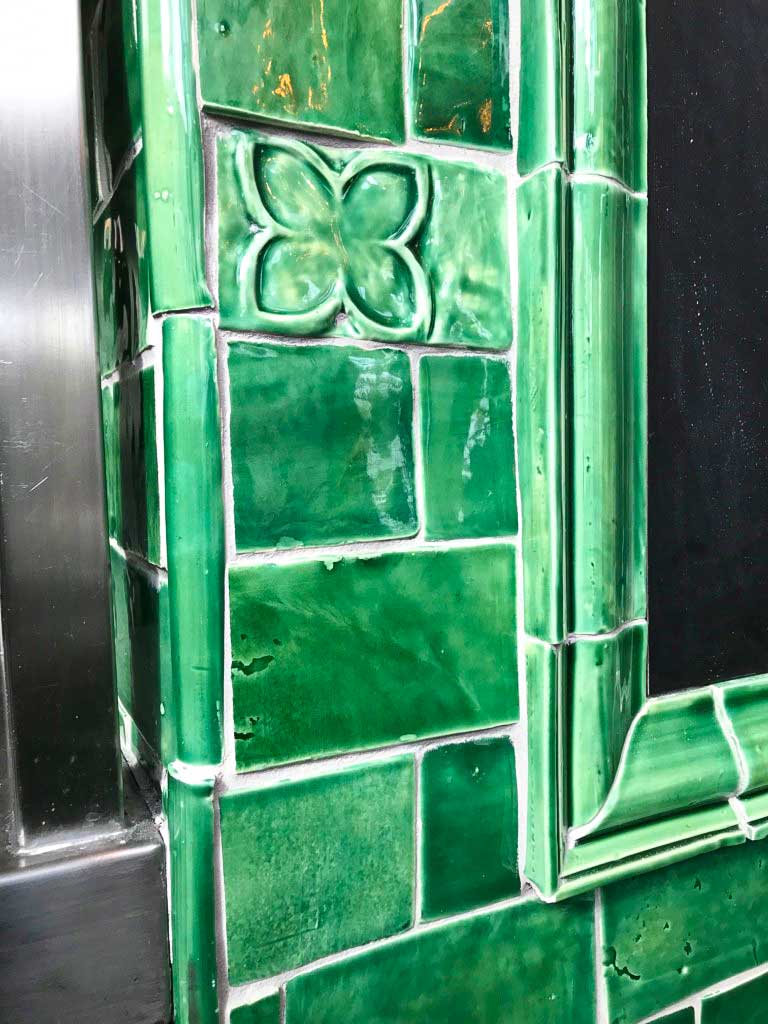 The architectural moulding of these green tiles makes for a perfect finish